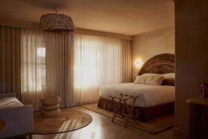 A bed or beds in a room at Swell Hotel Byron Bay - Adults Only