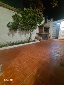 a patio with a brick floor in front of a garage at Departamento Pbaja centro Mendoza in Las Heras