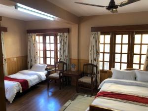 Postelja oz. postelje v sobi nastanitve Boudha Dungkar guest house
