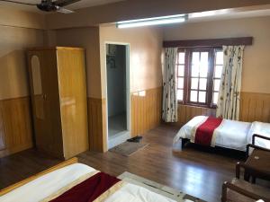 Postelja oz. postelje v sobi nastanitve Boudha Dungkar guest house