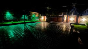 an empty street at night with green lights at Easy Inn Wayanad in Kaniyāmbetta