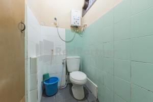 a bathroom with a toilet in a room at Homestay PKPN Garut Mitra RedDoorz in Garut +21 photos