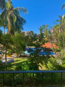 a view from the balcony of a resort with palm trees at De Vacaciones in Zihuatanejo