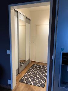 an empty hallway with a mirror and a rug at Apartment Malmö in Vaasa