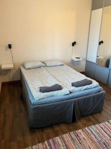 a bedroom with a bed with two pillows on it at Apartment Malmö in Vaasa