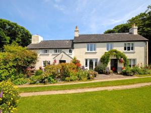 a large house with a garden in front of it at Llys Isaf in Saint Nicholas