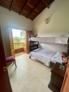 a bedroom with a bunk bed and a balcony at Casa Nonna in Barichara
