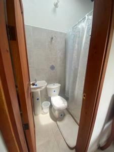 a small bathroom with a toilet and a sink at Casa Nonna in Barichara +10 photos
