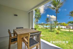 a dining room with a table and a view of the ocean at Studio Alamanda Baie Orientale in Orient Bay