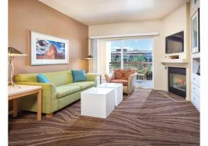 a living room with a couch and a fireplace at Exclusive Condo Retreat, Featuring a Lazy River - Special Offer Now! in Las Vegas