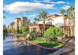 a building with palm trees in front of it at Exclusive Condo Retreat, Featuring a Lazy River - Special Offer Now! in Las Vegas