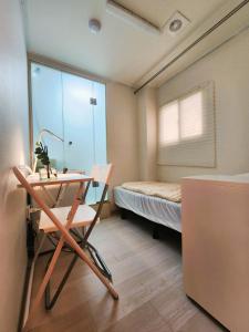 a room with a desk and a bed with a window at Oreum Stay Myeongdong - Female Only in Seoul