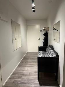 a living room with a couch and a hallway at Apartment Korsholma1 in Vaasa