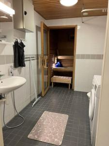 a bathroom with a sink and a shower and a toilet at Apartment Korsholma1 in Vaasa