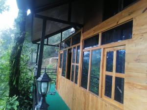 a building with windows and a street light next to it at Jungle Crown Organic Homestay in Nagarkot