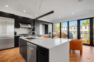 a kitchen with a white counter top and a large window at Central DC Home+Private Rooftop! (Unit B) in Washington, D.C.