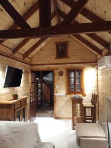 a living room with a couch and a tv in a room at CASITA DE MARIA in Paso de la Patria
