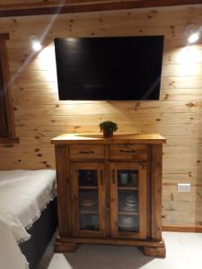 a flat screen tv on top of a wooden wall at CASITA DE MARIA in Paso de la Patria +3 photos