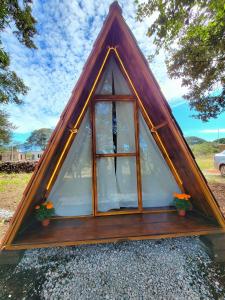 a frame tent with a window and some plants at Campestre Camp in Chignahuapan