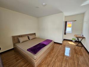 Klong Zand Resort في رايونغ: غرفة نوم بسرير وارضية خشبية