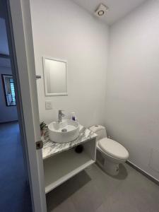 a bathroom with a sink and a toilet at En el centro de Guadalajara con vista a la ciudad in Guadalajara +27 photos