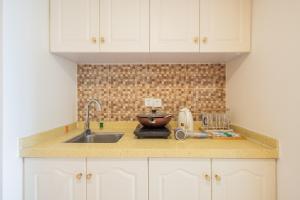 a kitchen with a sink and a counter top at Lavender Apartment Branch in Guangzhou