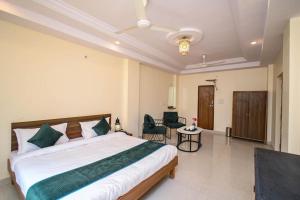 a bedroom with a large bed with a ceiling fan at Raj Residency in Jodhpur