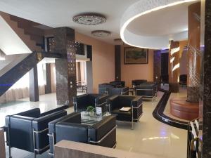 a salon with black chairs and a waiting room at Capital O 93263 Linge Land Hotel in Takengon