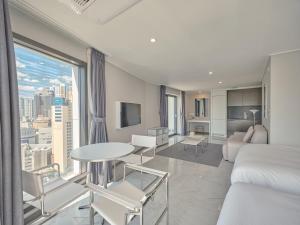 a hotel room with a bed and a large window at Y Collection by UH FLAT Haeundae beach in Busan