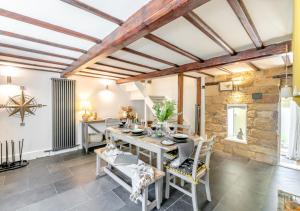 a dining room with a table and chairs at 1 Browcote Cottage in Ravenscar