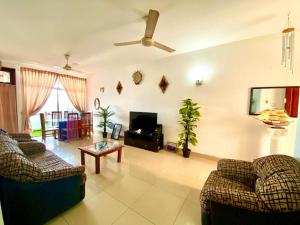 a living room with two couches and a tv at Mount view residences in Ratmalana