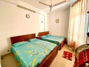 a bedroom with two beds and a window at Mount view residences in Ratmalana
