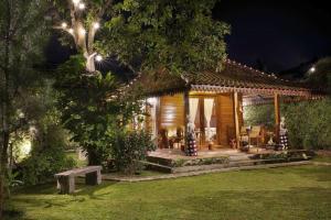 a house with a bench in a yard at night at Villa Arum Dalu in Semplak