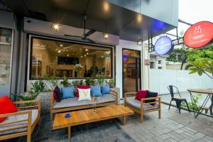 a patio with couches and a table and chairs at Suite Home Boutique Hotel in Phnom Penh