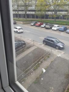 a view from a window of a parking lot with cars at Celebrity Home in Woolwich