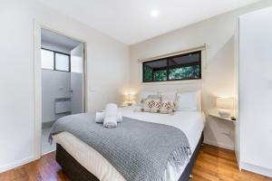 a bedroom with a large bed and two windows at BIG4 Tasman Holiday Parks - Bright in Bright