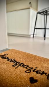 a brown rug sitting on the floor next to a chair at B71 - Appartement im Herzen des Schwarzwalds in Schramberg
