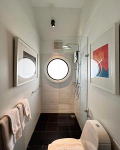 a bathroom with a toilet and a window at JARITT NyMMANH in Chiang Mai