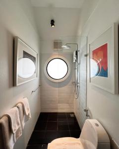 a bathroom with a toilet and a window at JARITT NyMMANH in Chiang Mai +58 photos
