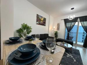 a dining room table with wine glasses and a dining room at Jewel of the Canal 809WB3 in Abu Dhabi