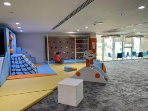 a childrens play room with a playground with a slide at Jewel of the Canal 809WB3 in Abu Dhabi
