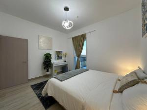a bedroom with a large white bed and a window at Jewel of the Canal 809WB3 in Abu Dhabi