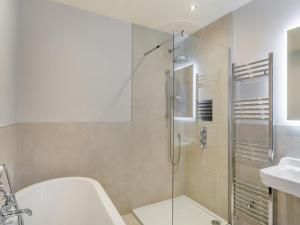 a bathroom with a shower and a toilet and a sink at Castle Townhouse in Knaresborough