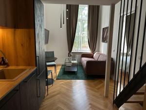 a living room with a couch and a table at M Loft3 in Kaunas