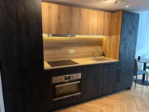 a kitchen with a sink and a stove top oven at M Loft3 in Kaunas +20 photos