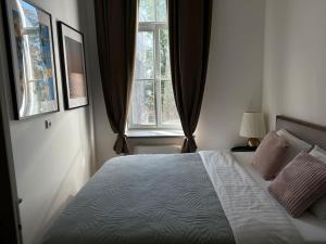 a bedroom with a large bed and a window at M Loft3 in Kaunas