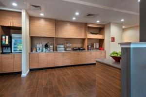 a large kitchen with wooden cabinets and a counter at TownePlace Suites by Marriott Nashville Goodlettsville in Goodlettsville