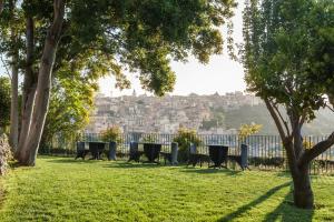 a park with benches and a view of a city at Giardino Sul Duomo in Ragusa