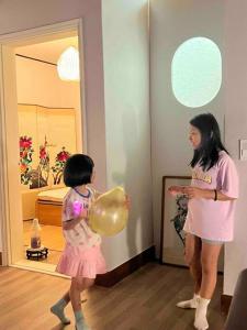 two young girls are standing in a room with balloons at Timeless Hanok In Jamsil Serenity in Seoul