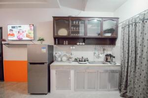 a small kitchen with a refrigerator and a sink at RB Modern Condos in Zamboanga